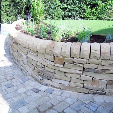 York Stone dry wall with plant borders and evergreen shrubs