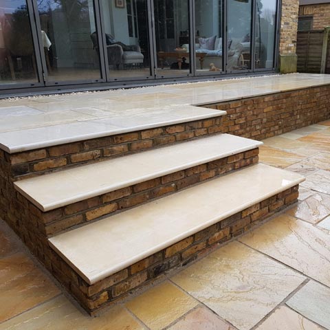 Fossil Mint Indian Sandstone patio and retaining wall in reclaimed London Stocks in Kingston-upon-Thames