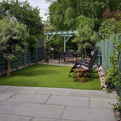 Large Pergola and Grey Indian Sandstone paving in family garden